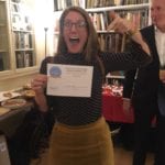 Lucy holding the People's Choice Blue Patch Award